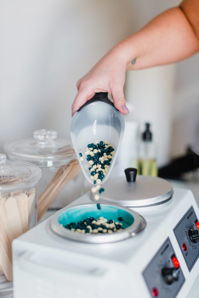 wax beads being poured into a wax melter