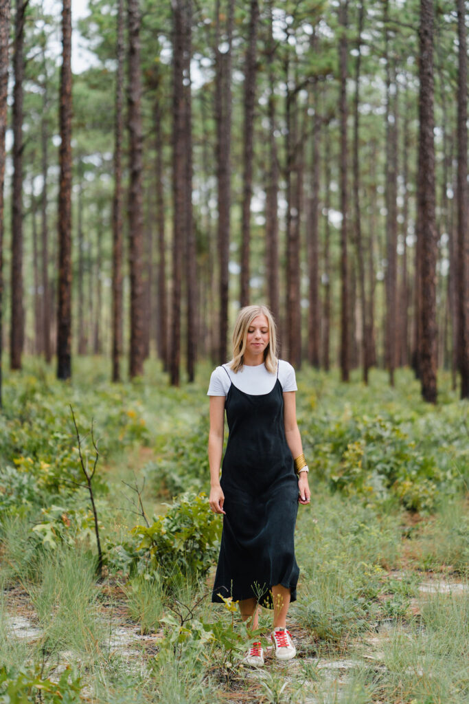 Girl in a black slip dress poses at Weymouth Woods in Southern Pines NC | Photo by Sara Coffin Photography