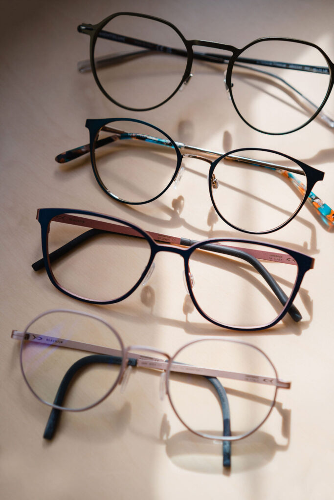 Birds eye view shot of four pairs of eyeglasses stacked