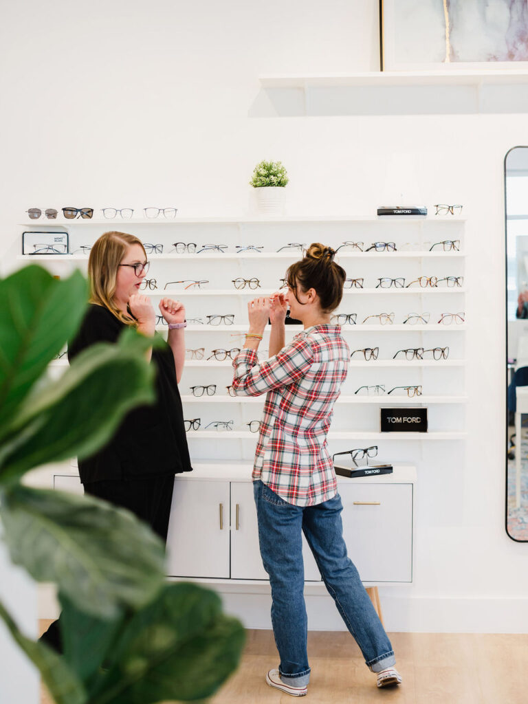 Eye doctor helps client shop for lenses inside modern eye doctors office | Business branding photography by Sara Coffin for The Vision Studio 