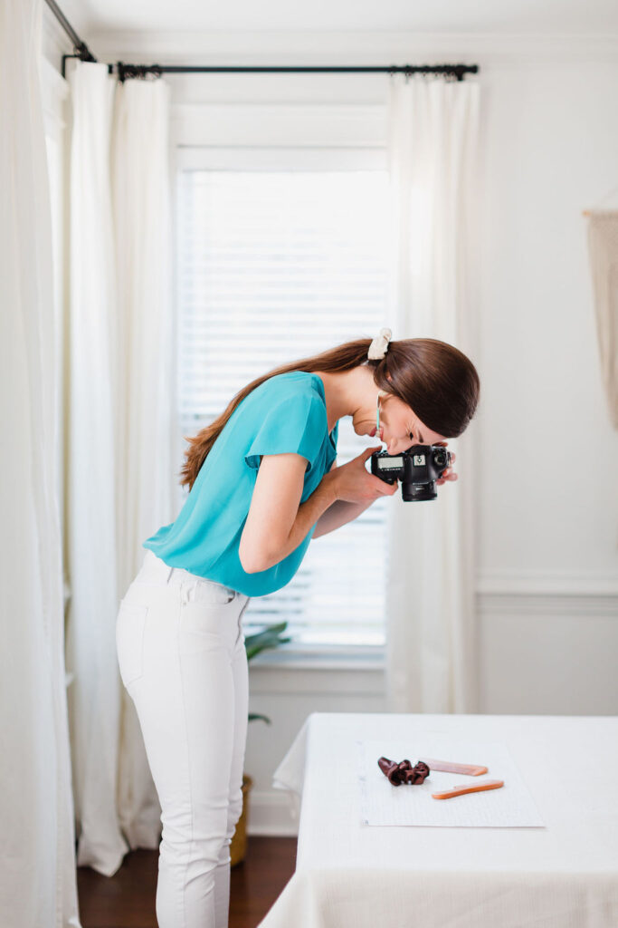 Photographer takes a detail shot of items sitting on a white tablecloth | Personal branding photography session in Charleston, SC for Michelle Fiorello